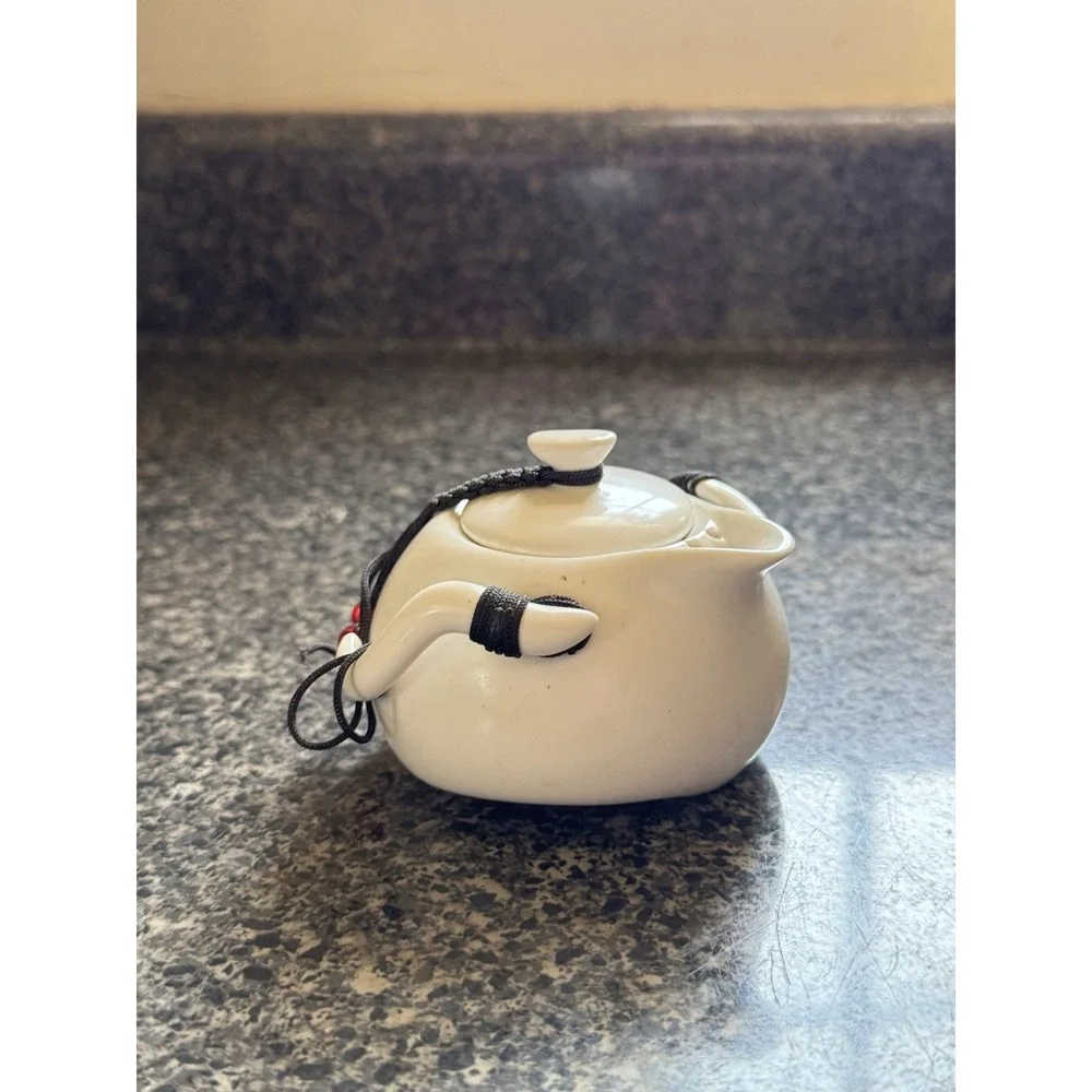 Compact travel tea pot white ceramic with decorative cord